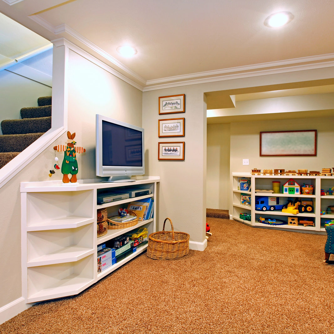 Play room in a white basement living room